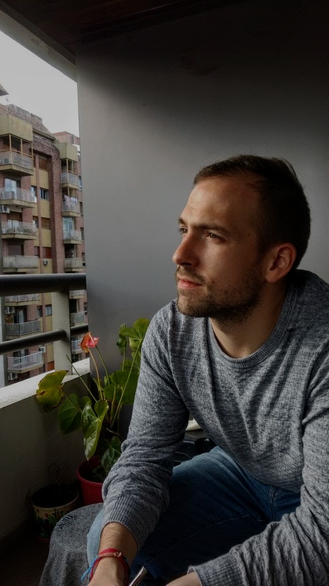 A picture of me sitting on a balcony looking contemplative